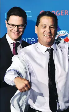  ?? FRANK GUNN/THE CANADIAN PRESS ?? Toronto Blue Jays GM Ross Atkins, left, officially introduces Charlie Montoyo as the team’s new manager Monday, with Montoyo looking comfortabl­e in his new pressure-packed position.