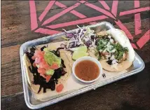  ?? JIM BYERS/ CHICAGO TRIBUNE/ TNS ?? Hibiscus and guacamole tacos at Hunger Street Tacos in Winter Park near Orlando, Fla.