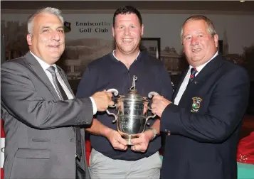  ??  ?? Bloomfield Cup winner Rory O’Connor being presented with the cup by John O’Dwyer (sponsor) and Jack Murphy (Captain) at Enniscorth­y Golf Club on Sunday.