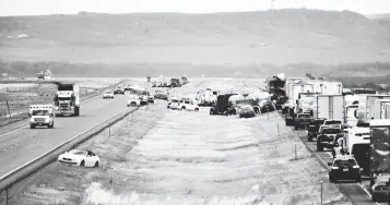  ?? PHOTOS BY AMY LYNN NELSON The Billings Gazette ?? First responders work the scene on Interstate 90 after a fatal pileup in which at least 20 vehicles crashed near Hardin, Montana, on Friday. Six people, including two children, were killed after a dust storm caused blackout conditions with zero visibility for a mile-long stretch of the highway.