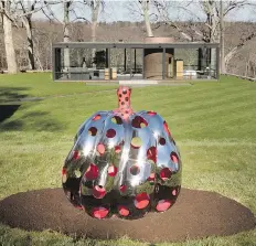  ?? RICHARD BARNES/THE GLASS HOUSE/THE ASSOCIATED PRESS ?? Overlookin­g The Glass House in New Canaan, Conn., Japanese artist Yayoi Kusama’s Pumpkin is four feet tall and made of red, glittering steel.