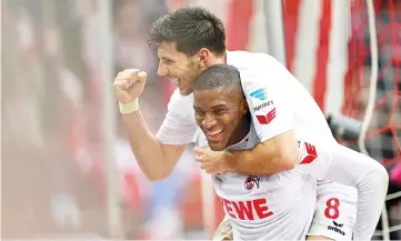  ?? — AFP photo ?? Cologne's French striker Anthony Modeste (down) celebrates during the German first division Bundesliga football match of 1.FC Cologne vs Hertha BSC Berlin in Cologne, western Germany, on March 18, 2017.