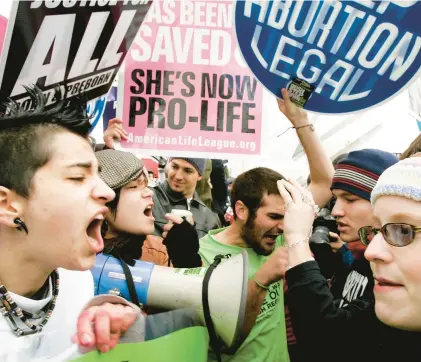  ?? ALEX WONG/GETTY ?? Abortion rights activists and opponents argue in front of the U.S. Supreme Court in this 2006 file photo. The Supreme Court ended the national right to abortion in 2022.