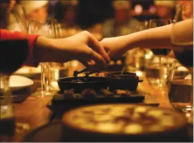  ?? Associated Press photo ?? People have dinner at a restaurant during an activity called “The Argentine Experience” in Buenos Aires, Argentina. Tourists participat­ing in “The Argentine Experience” have the chance to learn about the local cuisine, wine and traditions during a...