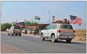  ?? AP ?? A U.S. military convoy is seen Monday near the Iraqi city of Dahuk. Defense Secretary Mark Esper said most of the forces withdrawn from Syria would be redeployed to western Iraq.