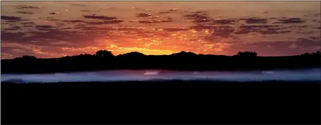  ?? COURTESY DON BOYD ?? Fog hangs over the landscape at sunrise on a mid-August morning at Bosque del Apache National Wildlife Refuge. When cool air moves over the warmer ground, still moist from the previous night’s rain, fog may occur low to the ground. This ghostly band lasts briefly as the air warms quickly with the rising sun. If you are not there before sunrise, you may miss it.