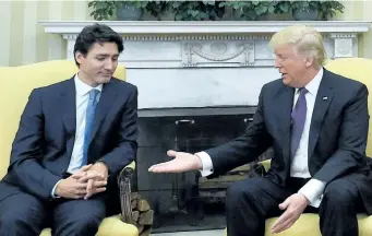  ?? SEAN KILPATRICK/THE CANADIAN PRESS ?? Prime Minister Justin Trudeau meets with U.S. President Donald Trump in Washington, D.C., on Monday. Despite this moment before the two shook hands, a joint statement on shared priorities seemed to suggest the first-in-person encounters between the...