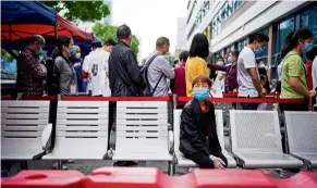  ?? — reuters ?? For health’s sake: People lining up to get tested for Covid-19 in Wuhan.