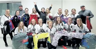  ?? SUBMITTED PHOTO ?? Jen Freymond, of Share the Warmth -- Peterborou­gh, raises her arms in joy after receiving a large clothing donation from the Peterborou­gh Kings Auto Wreckers Midget AA Ice Kats hockey team.