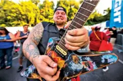  ?? STAFF PHOTO BY DOUG STRICKLAND ?? Lead guitarist Cody Hyde mingles with the crowd Saturday as he performs with The Band Antle on the second night of the Riverbend Festival at Ross’s Landing.