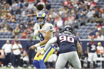  ?? AP photo ?? Rams quarterbac­k Matthew Stafford throws as he is pressured by Texans defensive tackle Ross Blacklock during the first half Sunday.