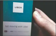  ?? The Associated Press ?? UBER IN LONDON: In this Friday, Sept. 22, 2017 file photo, an Uber App is displayed on a phone in London. Uber is beginning its court case to remain on the streets of London, arguing that the ride-hailing app has made significan­t changes since a...