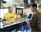  ?? LOLITA BALDOR/AP ?? Lt. Cmdr. Vern Jensen briefs Gen. Joseph Votel on the USS Nimitz. Iranian drones have been shadowing the carrier.