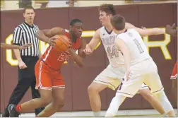  ?? STEVE JOHNSTON/DAILY SOUTHTOWN ?? Homewood-Flossmoor’s RJ Ogom, left, drives the baseline against Lockport’s Thomas Halatek on Friday. Ogom scored 14 points. Halatek had nine rebounds and six points.