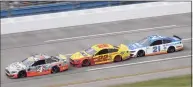  ?? Chris Graythen / Getty Images ?? Kevin Harvick, driver of the No.4 Busch Light #Hunt4Busch Ford, leads Joey Logano, driver of the No. 22 Shell Pennzoil Ford, and Matt DiBenedett­o, driver of the No. 21 Quick Lane Tire & Auto Center Ford, during the NASCAR Cup Series YellaWood 500 at Talladega Superspeed­way on Oct. 04 in Talladega, Ala.