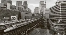  ?? Noriko Hayashi / Bloomberg ?? A Shinkansen bullet train travels in Tokyo. Similar trains will operate along a planned Houston-to-Dallas line which has gained federal approval.