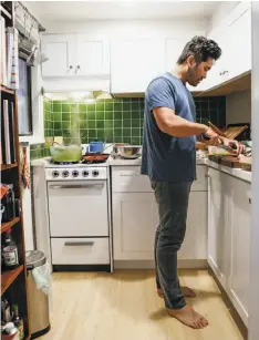  ??  ?? Jew in the tiny kitchen of his S.F. apartment: “I want to celebrate tradition, but I also want to make food that tastes good to me.”