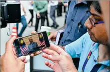  ?? XINHUA ?? A journalist uses his cellphone to see Malaysian Interim Prime Minister Mahathir Mohamad’s news conference in Kuala Lumpur, Malaysia, on Thursday.