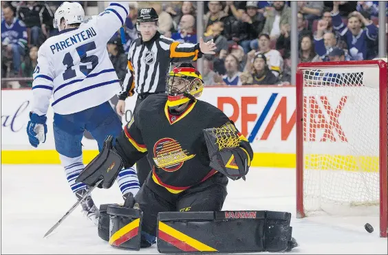  ?? GERRY KAHRMANN / PNG ?? Toronto’s Pierre-Alexander Parenteau celebrates the Leafs goal on Vancouver goalie Ryan Miller in the second period of Saturday’s game at Rogers Arena. The Leafs scored two empty-net goals and beat the Canucks 5-2.