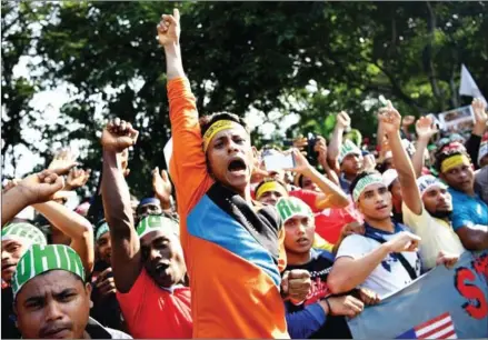  ?? MANAN VATSYAYANA/AFP ?? Ethnic Rohingya Muslim refugees shout slogans during a gathering in Kuala Lumpur on December 4 against the persecutio­n of Rohingya Muslims in Myanmar.