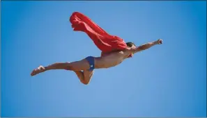  ?? JAVIER SORIANO / AGENCE FRANCE-PRESSE ?? Czech diver Michal Navratil flies through the air as Superman for a joke following the men’s high diving final in Barcelona on Wednesday.