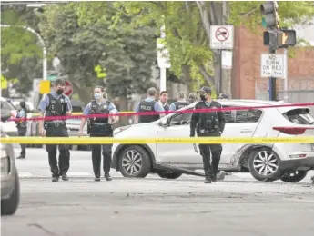  ?? TYLER LARIVIERE/SUN-TIMES ?? An 8-year-old girl was killed and two others wounded when their car was fired at Monday afternoon at 47th and Union.