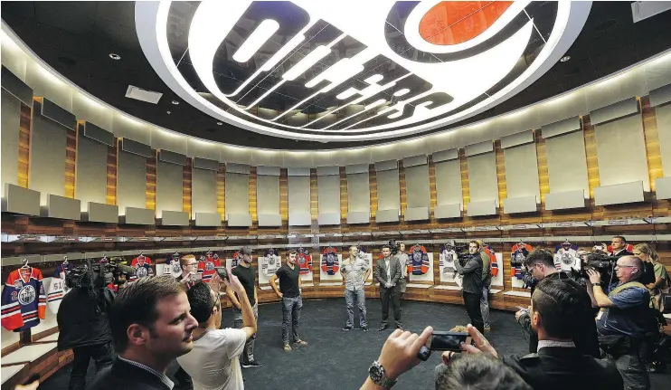  ?? — POSTMEDIA ?? Members of the Edmonton Oilers are on hand as the media gets a first look at the facilities inside the impressive new Rogers Place in Edmonton Wednesday.