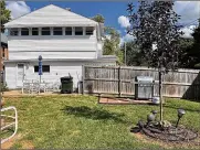  ?? ?? In back is a concrete patio, newer full privacy fence and a four-season room above the garage.