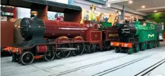  ?? DAVID ROUNCE ?? Bassett-Lowke’s 15in gauge pioneer Little Giant stands alongside the firm’s only internal combustion locomotive Blacolvesl­ey at the Ravenglass Railway Museum on June 12.