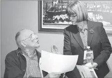  ?? CHRIS SHANNON - CAPE BRETON POST ?? Big Pond resident John MacDonald has a spirited discussion on equalizati­on payments with Finance Minister Diana Whalen at a tax and regulatory review consultati­on session at the Joan Harriss Cruise Pavilion in Sydney on Monday.