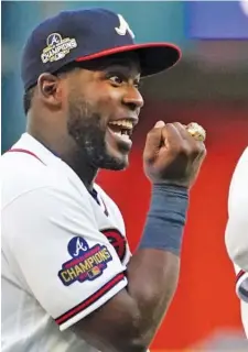  ?? AP PHOTO/JOHN BAZEMORE ?? Atlanta Braves center fielder Guillermo Heredia shows off his World Series ring during a ceremony before Saturday night’s home game against the Cincinnati Reds.