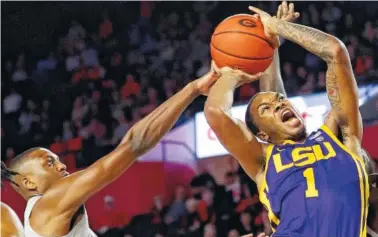  ?? AP PHOTO/JOHN BAZEMORE ?? LSU guard Ja’vonte Smart, right, is fouled by Georgia guard Tye Fagan on Saturday in Athens, Ga. No. 19 LSU held off Georgia for an 83-79 victory.
