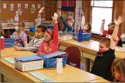  ?? BILL LACKEY/STAFF ?? First grade students from Reid School raise their hands Monday at The Village. Some students and teachers had to be relocated to other buildings in the Clark Shawnee School District after Reid became unsafe.