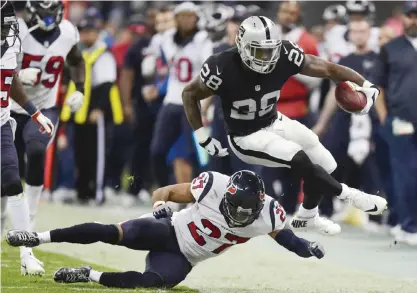  ??  ?? MEXICO CITY: Oakland Raiders Latavius Murray (28) eludes the tackle of Houston Texans Quintin Demps (27) during the 2016 NFL week 11 regular season football game on Monday at the Azteca Stadium in Mexico City. Oakland won 27-20. — AFP