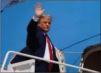  ?? The Associated Press ?? TRUMP: President Donald Trump waves while boarding Air Force One as he departs Wednesday at Andrews Air Force Base, Md. Trump was en route to Minnesota.