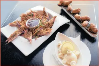  ?? PICTURES: MARILYN BERNARD ?? TAKE YOUR PICK: These simple meals will leave you with more time to spend with your loved one tomorrow. At the back, left, are Cupid’s coconut-rusted prawns; on the right are the mussels shallow-fried in a light chilli-bite batter.