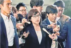  ??  ?? Inada (centre) is surrounded by reporters after reports of the launch of a North Korean missile, upon her arrival at Abe’s official residence in Tokyo in this file photo. — Reuters photo