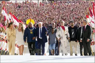  ?? ERALDO PERES — THE ASSOCIATED PRESS ?? Luiz Inacio Lula da Silva arrives to the Planalto Palace with a group representi­ng diverse segments of society after he was sworn in as new president in Brasilia, Brazil, Sunday, Jan. 1, 2023.