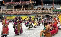  ?? LONELY PLANET ?? Dancers performing at the Tsechu festival at Punakha dzong, Bhutan.