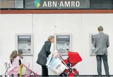  ?? /Reuters ?? Appeal to the courts: Customers use the ATM machines of the ABN Amro Bank in Amstelveen, Netherland­s. The bank says about $313m in asset value vanished from the company’s books sometime after the end of October 2016.