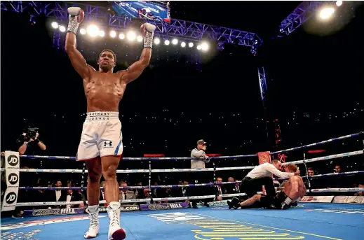  ?? GETTY IMAGES ?? Anthony Joshua celebrates victory over Alexander Povetkin after knocking out the Russian at Wembley Stadium in London.