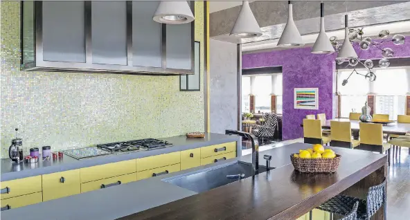  ?? MARCO RICCA/DRAKE/ANDERSON/THE ASSOCIATED PRESS ?? Manhattan-based firm Drake/Anderson created this kitchen in New York’s Tribeca neighbourh­ood to flow seamlessly into the main living space by repeating touches of colour throughout, echoing the mosaic backsplash pattern in the chair upholstery. Using...