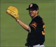  ?? JAE C. HONG — THE ASSOCIATED PRESS, FILE ?? Giants pitcher Kevin Gausman catches a ball during the team’s spring workout on Feb. 26 in Scottsdale, Ariz.