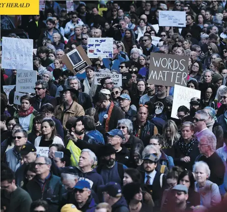  ?? BRENDAN SMIALOWSKI / AFP / GETTY IMAGES ?? People protesting against President Donald Trump gather near the Tree of Life synagogue Tuesday in Pittsburgh, Penn. Funerals were held on Tuesday for four of the victims of the anti-Semitic attack that left 11 worshipper­s dead on Saturday.