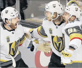  ?? AP PHOTO ?? Vegas Golden Knights’ William Karlsson, centre, celebrates with James Neal, left, and Jonathan Marchessau­lt after scoring the winning goal in double overtime against the San Jose Sharks during NHL playoff action Monday night in Las Vegas. The Golden...