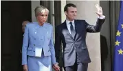  ?? — AFP ?? Newly-elected French President Emmanuel Macron poses with his wife Brigitte Trogneux at the Elysee presidenti­al Palace in France on Sunday prior to the inaugurati­on ceremony.