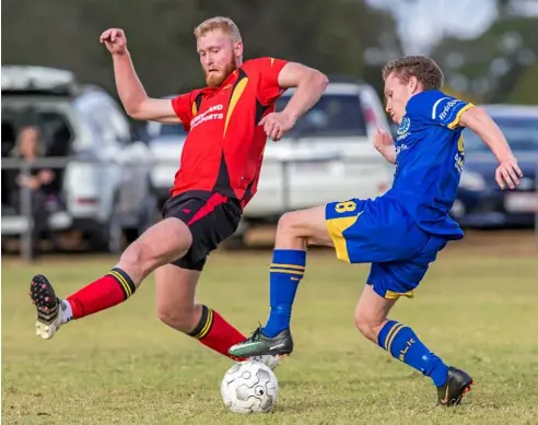  ?? Photo: Paul Smith ?? CLOSE CONTEST: USQ FC’s Jedd Sugden attempts to evade Kurt Neuendorft’s tackle. USQ won the Toowoomba Football League premier men’s match 2-1.