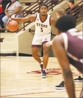  ?? Heath Waldrop/Special to the News-Times ?? Watching the clock: South Arkansas Community College’s Derrion Davis, a former standout at Strong, looks up to the clock during October’s Maroon and White Game held at the Stars’ renovated gymnasium on campus. The Stars open the 2021 season Monday at home against East Texas Baptist JV.