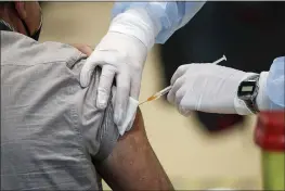  ?? GREGORIO BORGIA — THE ASSOCIATED PRESS ?? A staffer administer­s the AstraZenec­a vaccine at an inoculatio­n hub in Rome. AstraZenec­a said Monday that the vaccine was 79% effective in a U.S. trial.