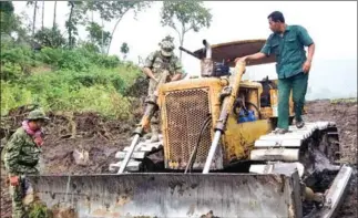 ?? CHEA HEAN ?? Environmen­tal officers inspect a bulldozer used to clear 51 hectares of land in a Kampong Speu province protected area.